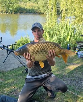 Angler with a carp caught at Alderwood Fishery