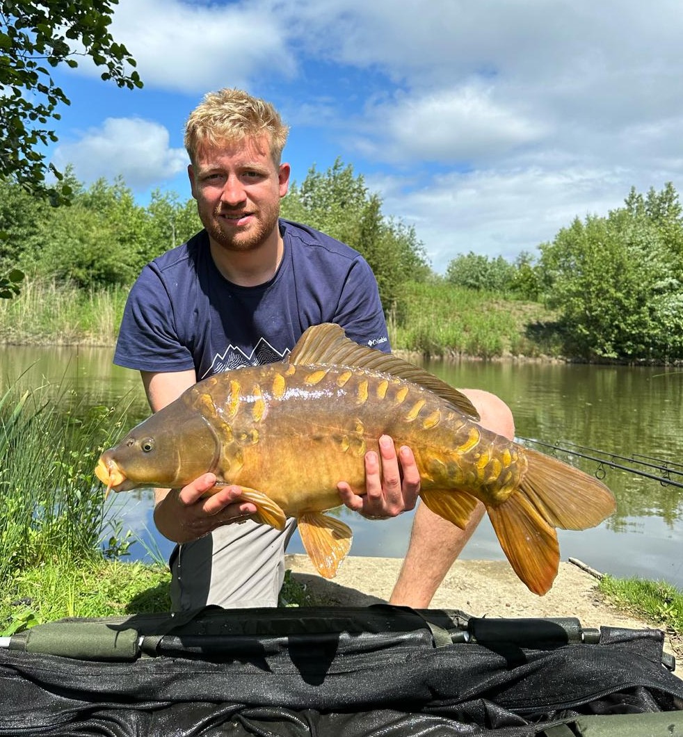 Angler with a carp caught at Alderwood Fishery