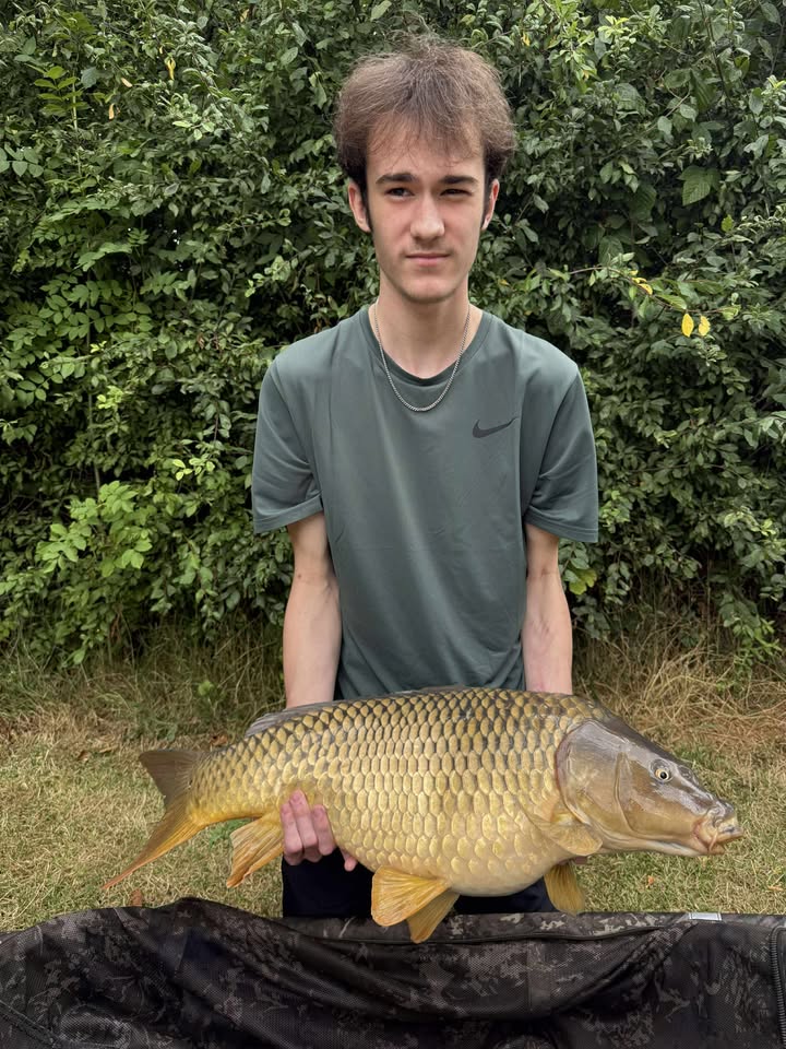 Angler with a carp caught at Alderwood Fishery