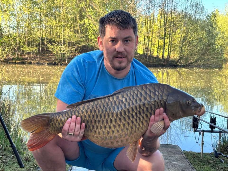 Angler with a carp caught at Alderwood Fishery
