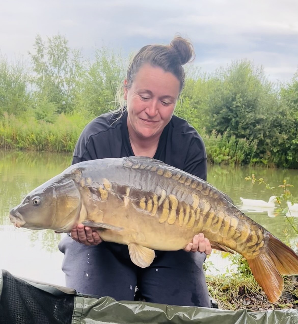 Angler with a carp caught at Alderwood Fishery