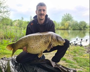 Angler with a carp caught at Alderwood Fishery
