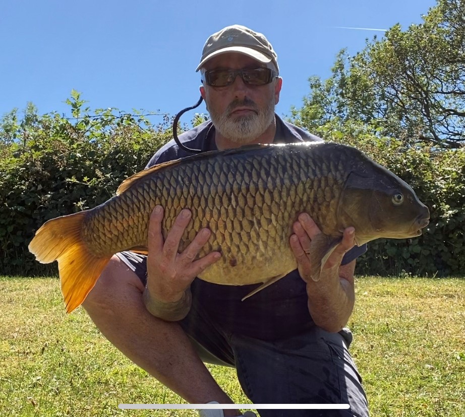 Angler with a carp caught at Alderwood Fishery