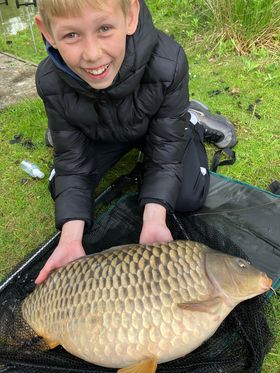 Angler with a carp caught at Alderwood Fishery