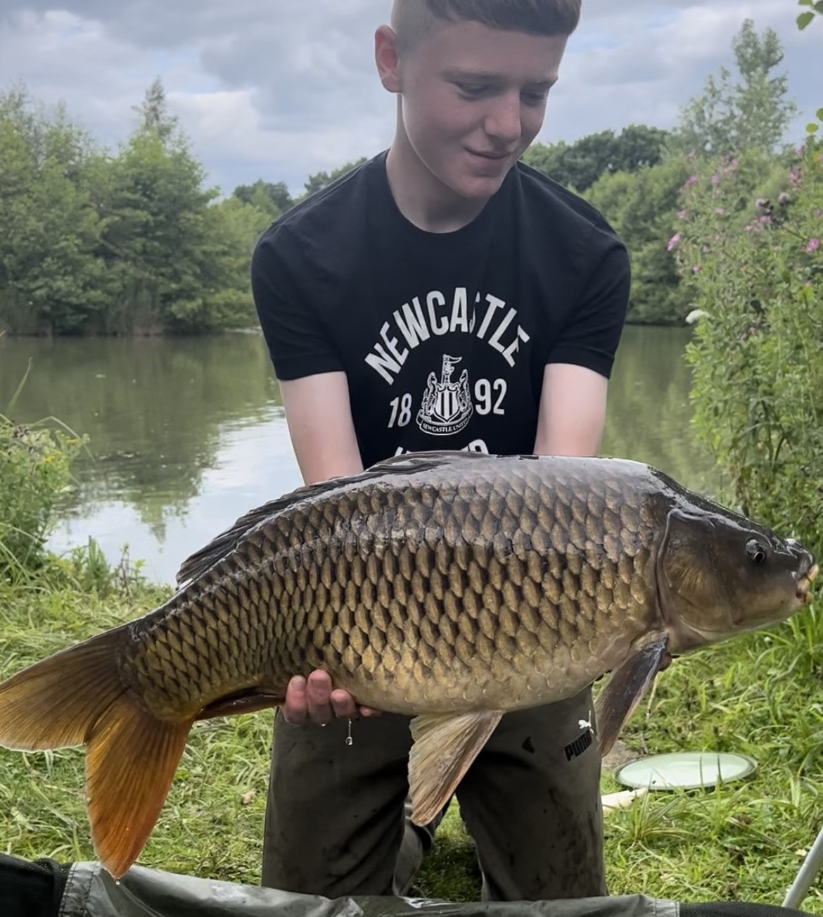 Angler with a carp caught at Alderwood Fishery