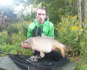 Angler with a carp caught at Alderwood Fishery