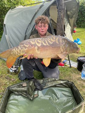 Angler with a carp caught at Alderwood Fishery