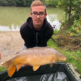 Angler with a carp caught at Alderwood Fishery