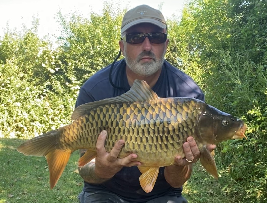 Angler with a carp caught at Alderwood Fishery