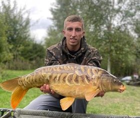 Angler with a carp caught at Alderwood Fishery